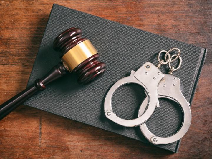 handcuffs and gavel on table